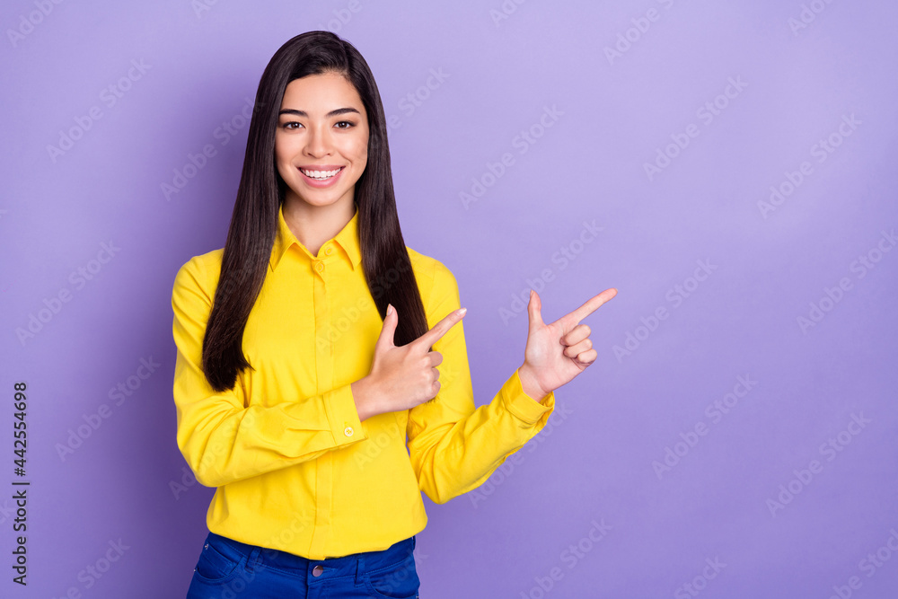 Photo of attractive young pretty lady point fingers empty space promo sale isolated on purple color background Photo of attractive young pretty lady point fingers empty space promo sale isolated on purple color background