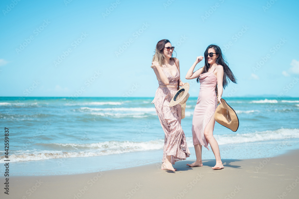 Two Asian women jogging on the beach in the morning. Rest time and holidays