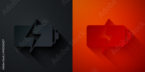 Paper cut Battery icon isolated on black and red background. Lightning bolt symbol. Paper art style. Vector