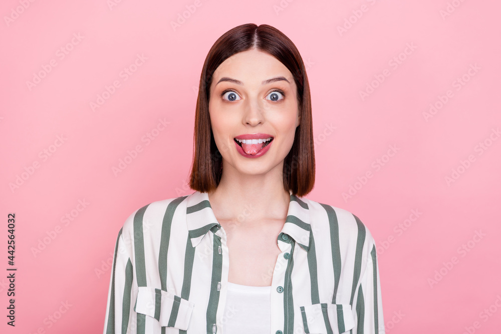 Photo of lovely brunette lady tongue out wear white shirt isolated on pink color background Photo of lovely brunette lady tongue out wear white shirt isolated on pink color background