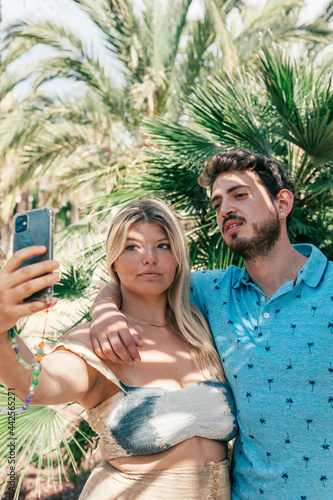 Couple taking a selfie. Tropical background. Concept travel