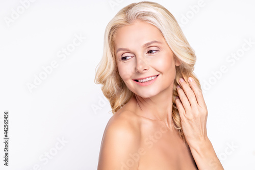 Profile side view portrait of attractive cheerful dreamy grey-haired woman touching smooth hair copy space isolated over white color background
