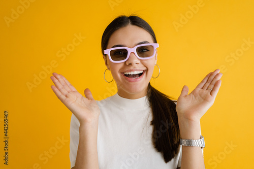 Young brunette woman in sunglasses laughing and gesturing