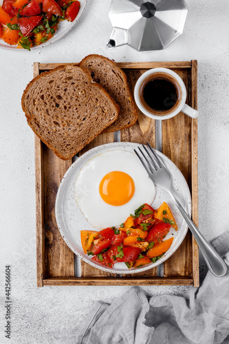 Fototapeta Naklejka Na Ścianę i Meble -  breakfast with fried eggs ang vegetables, toasts and coffie.  hight key