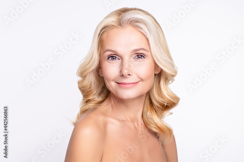 Portrait of attractive cheery grey-haired woman with pure clean clear smooth tanned skin isolated over white color background