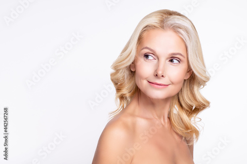Portrait of attractive curious healthy grey-haired woman looking aside copy blank space healthcare isolated over white color background