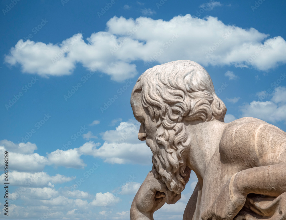 Socrates, the ancient Greek philosopher statue and blue sky with some clouds, Athens Greece