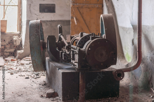 The steam engine in abandoned distillery next to the palace
