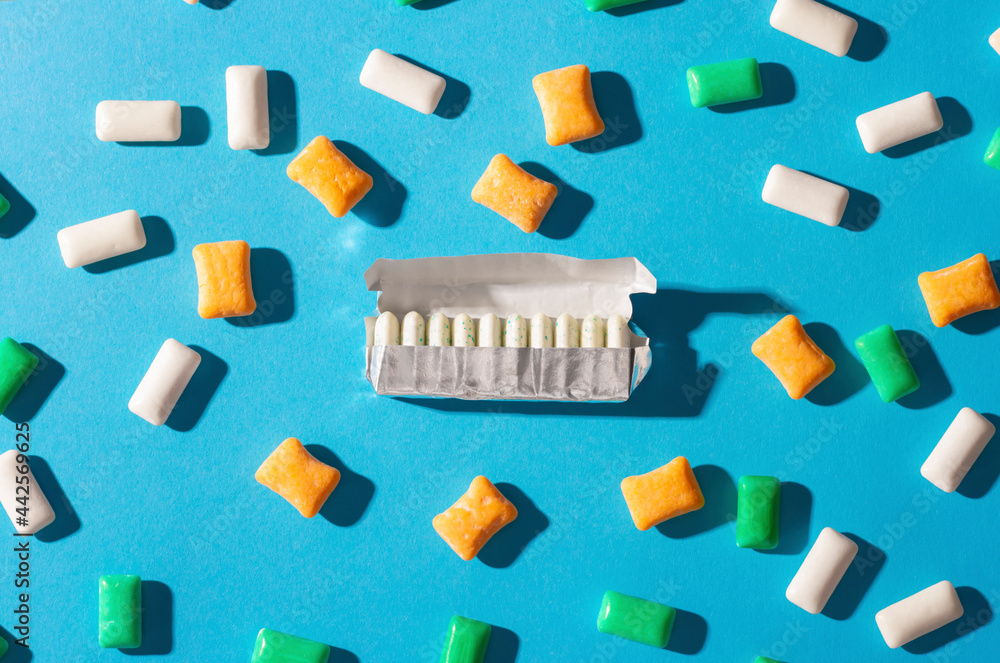 Multi-colored chewing gum on a blue background Multi-colored chewing gum on a blue background