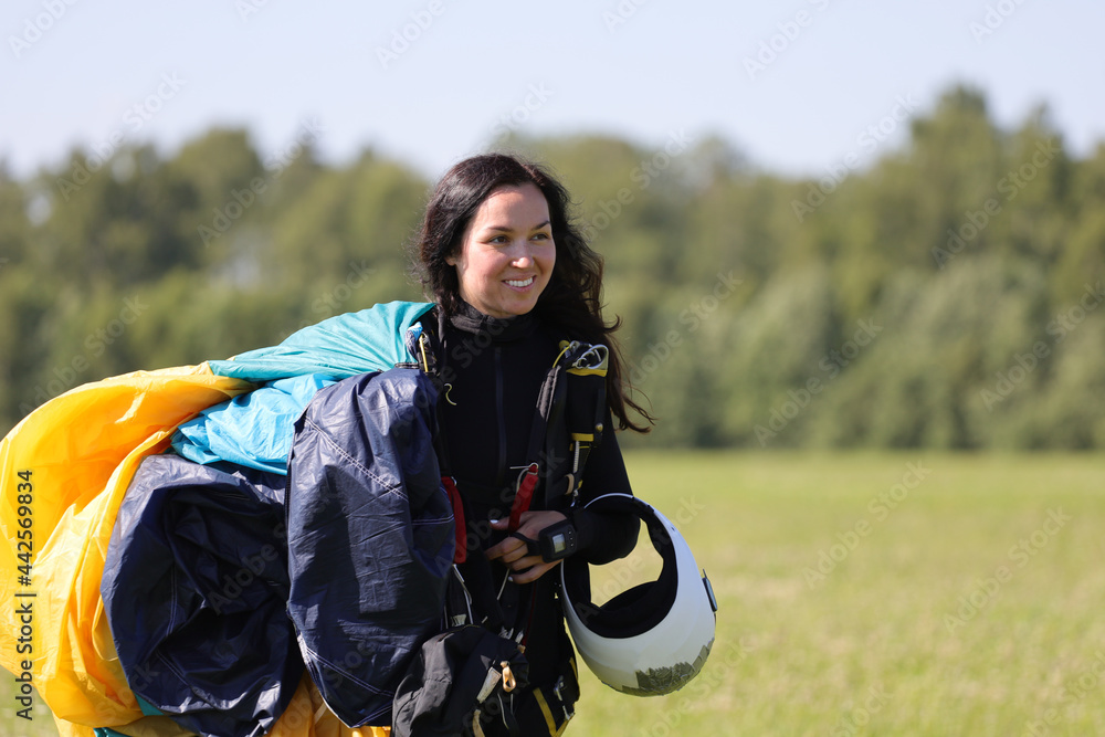 Skydiving. A happy woman is going back after landing.