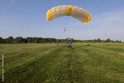 Skydiving. Tandem jump. The tandem just landed on the field.