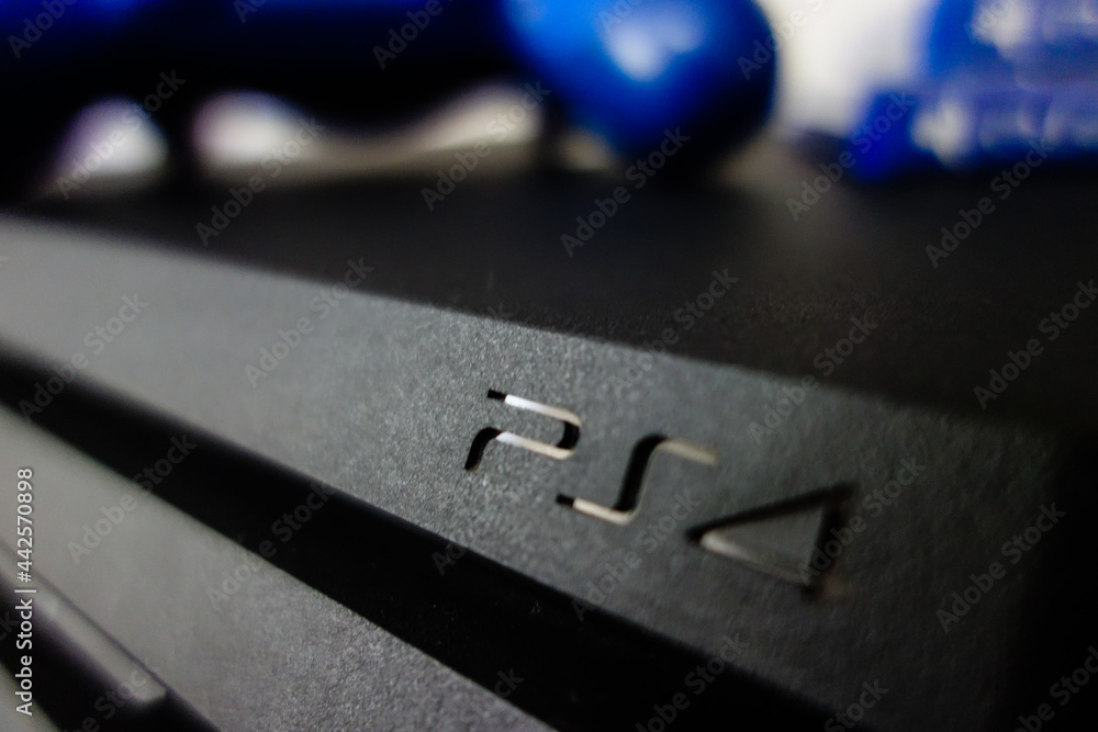 Sony black Playstation 4 Pro game console and blue wireless controller. PS4  symbol foto de Stock | Adobe Stock
