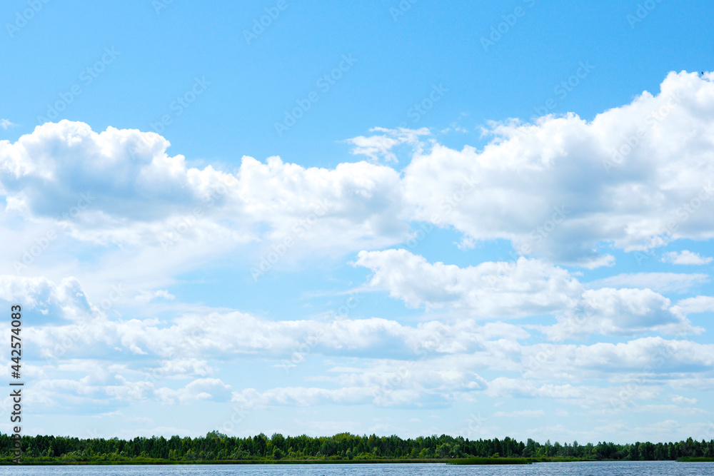 Obraz premium beautiful landscape dark blue lake, green forest and cloudy sky..