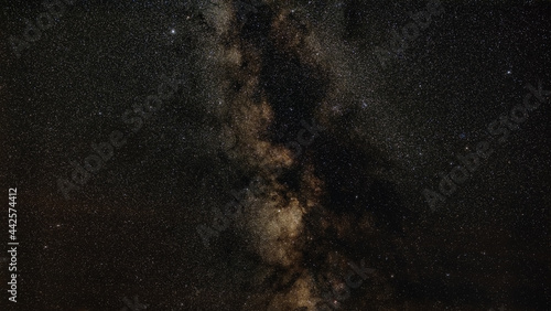 Night sky, many stars with milky way around Aquila and Scutum constellation visible. Long exposure stacked photo