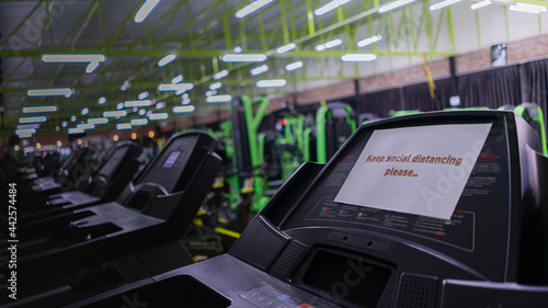 New normal Gym and Fitness. The treadmill is labeled message "Keep Social distancing" and Some treadmills are activated to prevent the spread of coronavirus.
