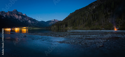 Evening mood at the Haldensee with reflecting lights in the lake, Tirol, Austria