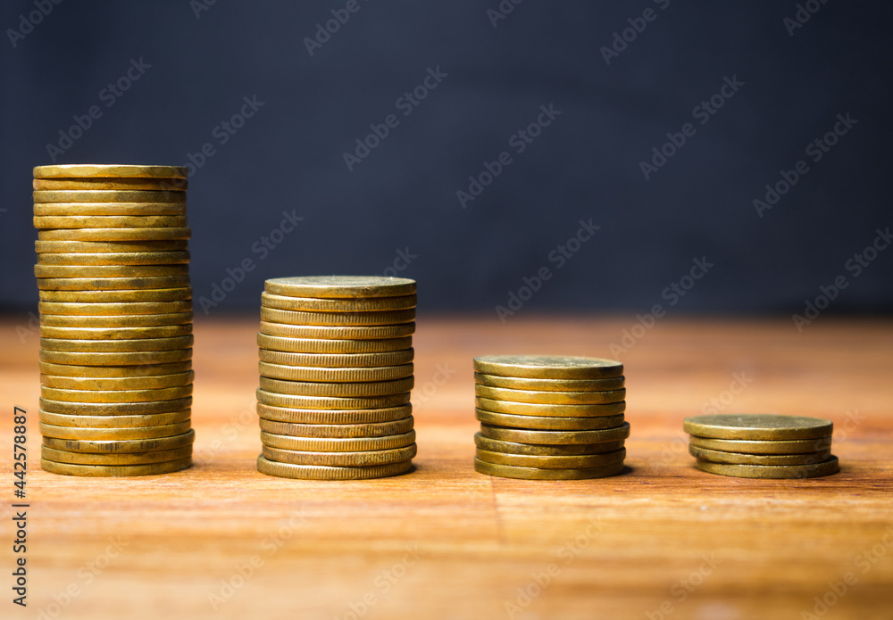 Stacked coins in the form of a graph of loss of money, economic crisis. Representation of savings expenses Stacked coins in the form of a graph of loss of money, economic crisis. Representation of savings expenses