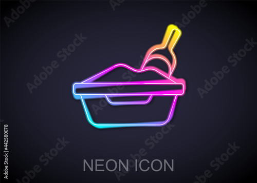 Glowing neon line Cat litter tray with shovel icon isolated on black background. Sandbox cat with shovel. Vector