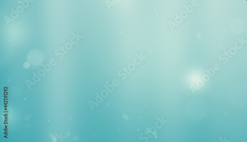 blue background with blurred particles and light rays