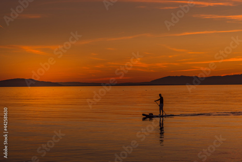 Unrecognized person during beautiful sunset in the coast from a body board table © fotosdanielgbueno