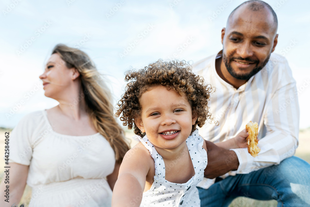 Smiling multiracial family having picnic in summer Smiling multiracial family having picnic in summer