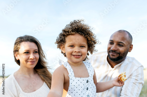 Smiling multiracial family having picnic in summer photo