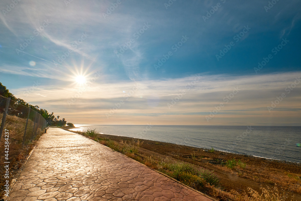 The sun on the promenade, beach side, in the warm morning sun, you can stroll along the promenade.