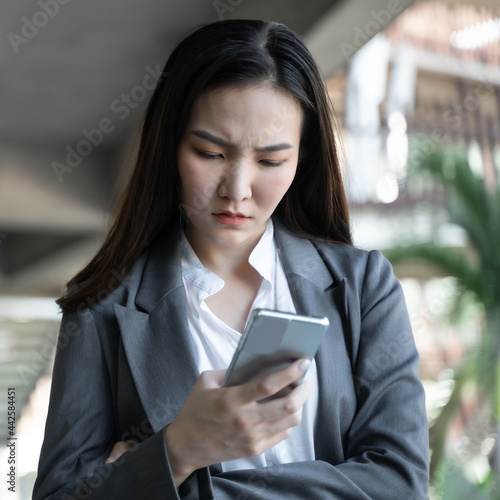 Serious young asian business woman received mail with bad news. business technology concept