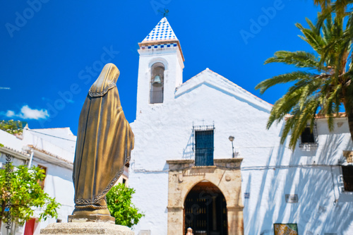 Fountain with Virgin in the Plaza da del Santro Cristo and Ermita del Santísimo Cristo de la Vera Cruz (Ermita del Santo Cristo de la Vera Cruz), Marbella Vieja, Spain. photo