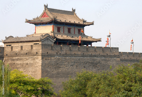 City Wall, Xian, Shaanxi Province, China. The City Wall of Xian is one of the largest and best preserved city fortifications in China. Watchtower on Xian city wall overlooking trees.