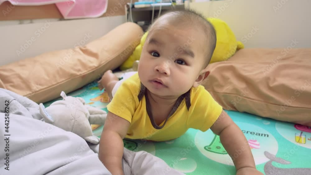 Asian baby boy laying and feeling happy relaxing and smiling on the bed Asian baby boy laying and feeling happy relaxing and smiling on the bed
