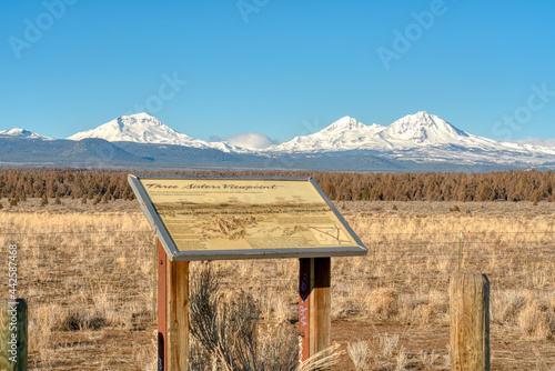 Three Sisters Mountains in Oregon with an informational sign photo