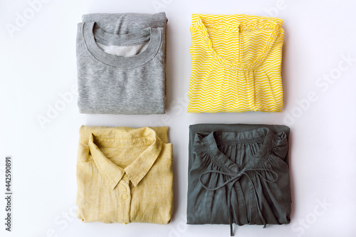 neatly arranged women's clothing in gray and yellow colors
