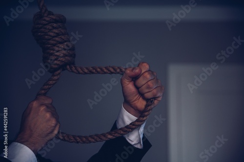 Hands hold the hanging death loop. Suicide concept.