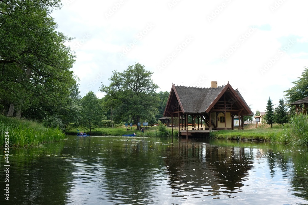 A wooden house by the river Zbrzyca, a resting place for canoeists. Laska, Bory Tucholskie, Poland A wooden house by the river Zbrzyca, a resting place for canoeists. Laska, Bory Tucholskie, Poland