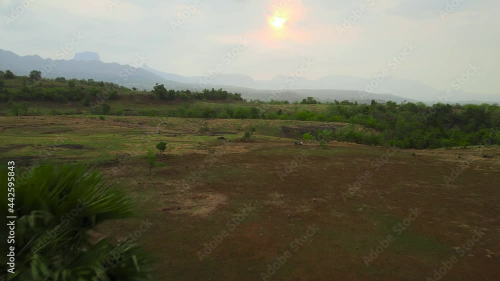 Flying towards the mountains during sunset or aerial view of table landscape Flying towards the mountains during sunset or aerial view of table landscape