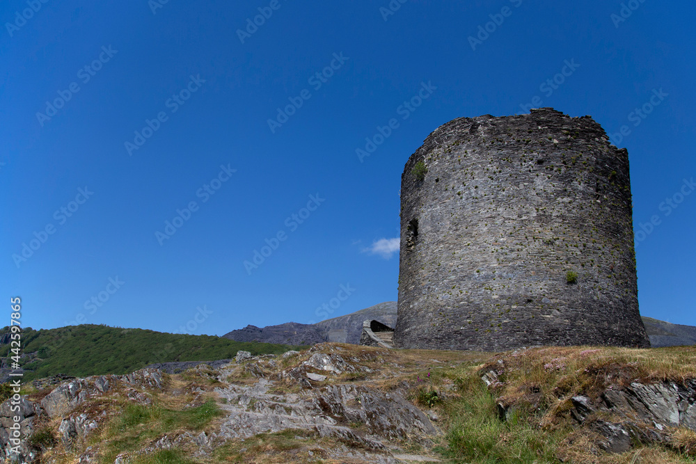 Dolbadarn Castle in Llanberis, Gwynedd,  North Wales.  Medieval castle on a hill with a blue sky