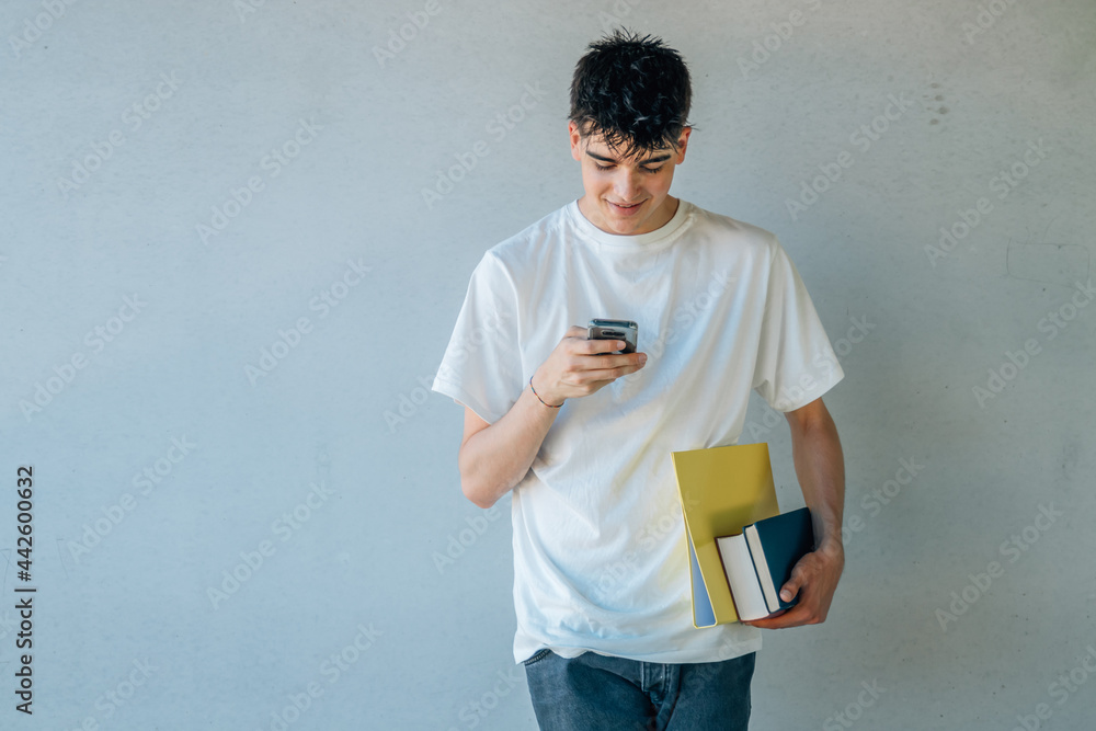 teenage student with books and mobile phone teenage student with books and mobile phone