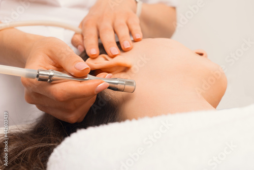 Close up photo of woman having facial treatment with vacuum
