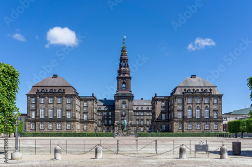 view of the historic landmark Christiansborg Castle in downtown Copenhagen under a blue summer sky