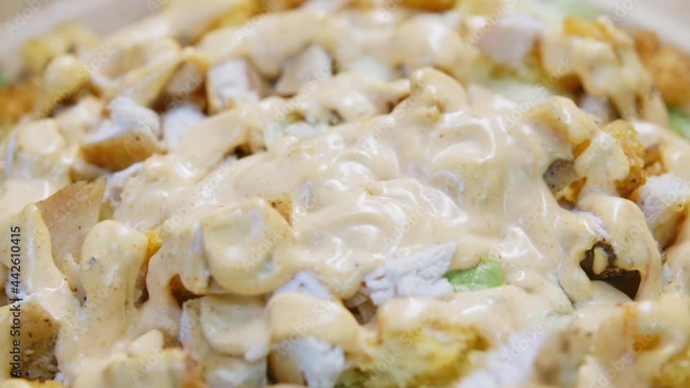 Caesar salad is prepared in the restaurant kitchen. Caesar salad is prepared in the restaurant kitchen.