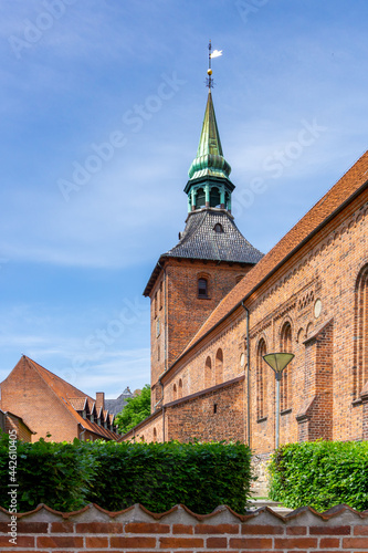 vertical view of the historic red brick church in the old town center of Svendborg photo