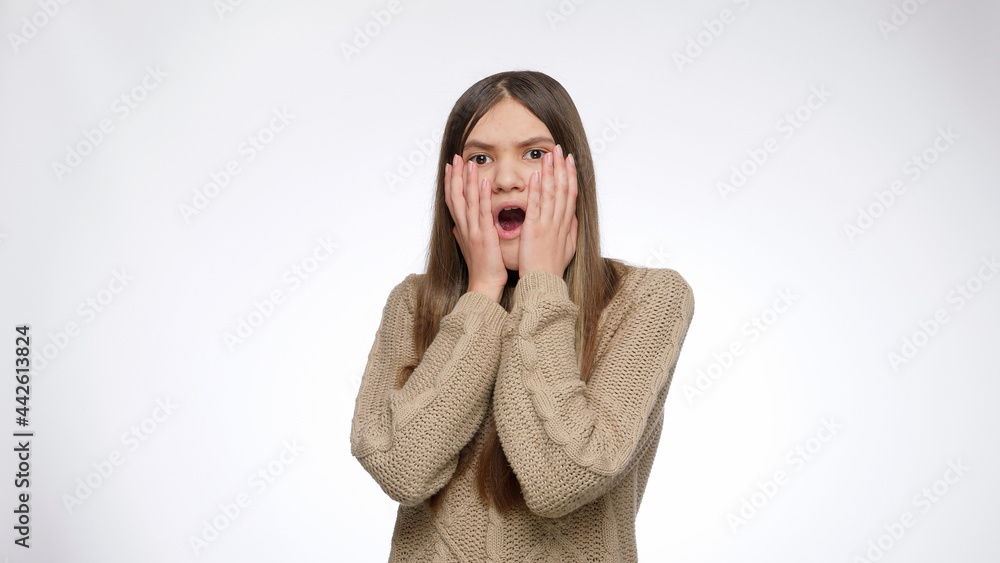 Shocked or surprised girl opens mouth and closes it with hands. Shocked or surprised girl opens mouth and closes it with hands.