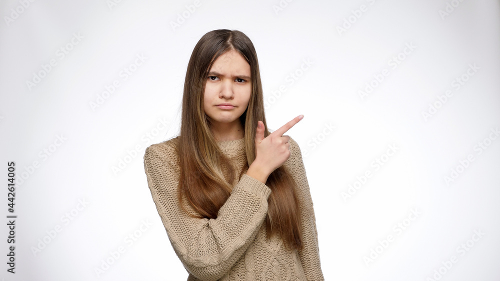 Yougn confident girl pointing with index finger on the side Yougn confident girl pointing with index finger on the side