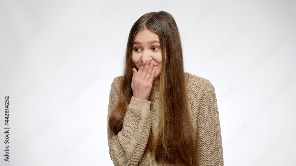 Αυτοκόλλητο Portrait of girl closing her mouth while scoffing or mocking of someone