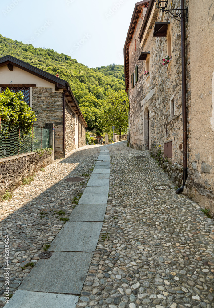 Narrow streets with stone houses in the small mountain village of Bassola, hamlet of Armeno above Lake Orta in the province of Novara, Piedmont, Italy