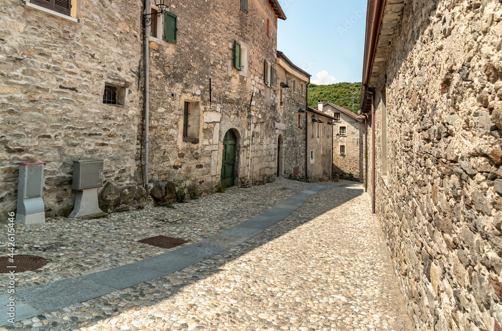 Narrow streets with stone houses in the small mountain village of Bassola, hamlet of Armeno above Lake Orta in the province of Novara, Piedmont, Italy