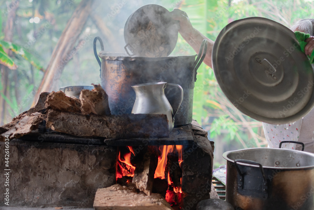 Cooking soot filled pots on top of a wood stove