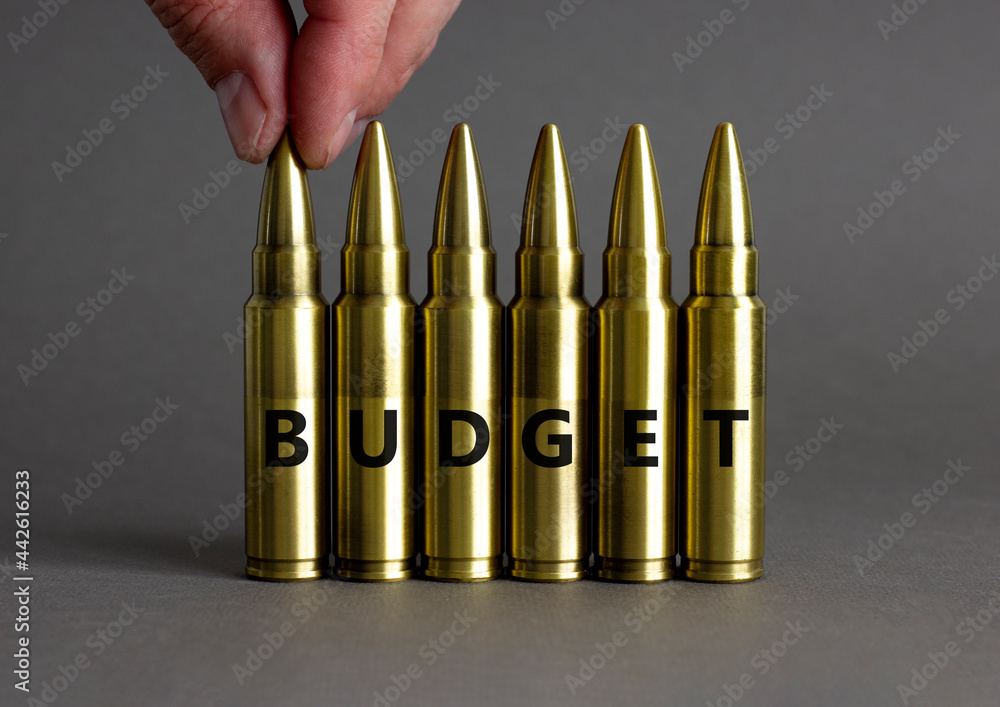 Budget symbol. Ammunitions imitation with the word BUDGET. Beautiful grey background, copy space. Business and budget concept. Budget symbol. Ammunitions imitation with the word BUDGET. Beautiful grey background, copy space. Business and budget concept.