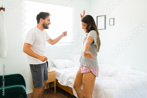 Adorable couple dancing together in the bedroom